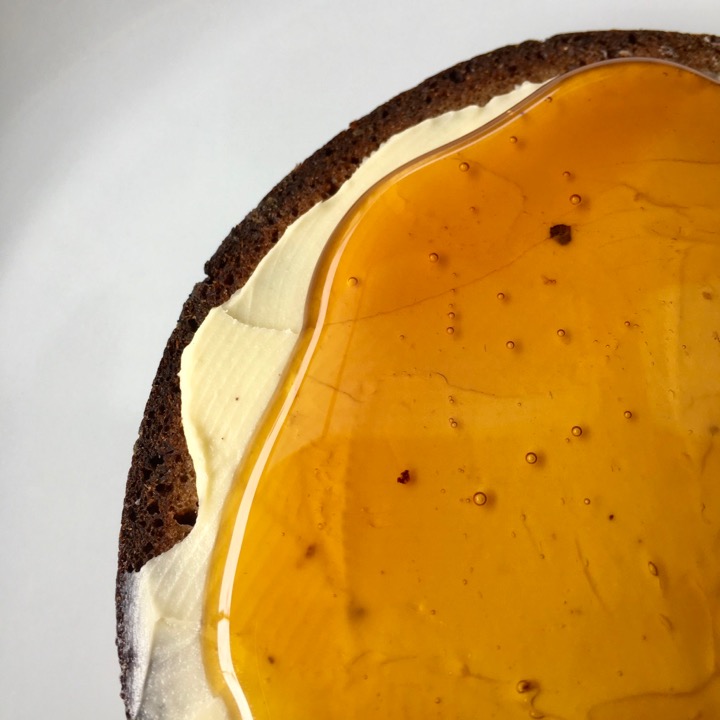 Amber honey on black bread with butter