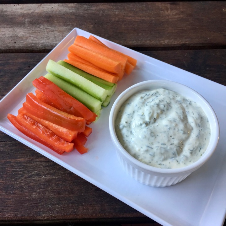 Dip and vegetables on a white plate