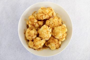 Cauliflower with brown butter on a white plate